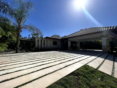a house with a large patio in front of it at Villa Cajuiles 13, Casa de Campo in La Romana