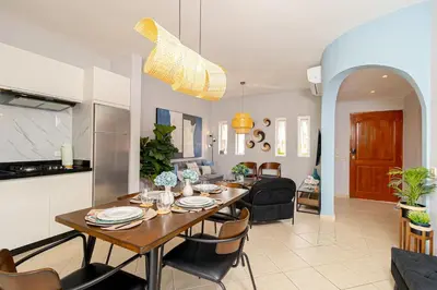 a dining room and living room with a table and chairs at Charming 1 Bedroom in Tamarindo Dominicus With Pool in La Laguna