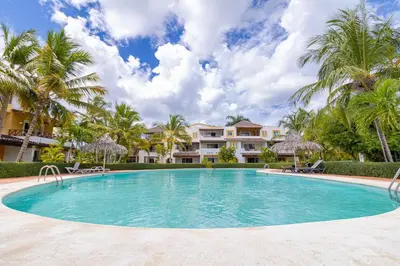 a swimming pool in front of a villa at Charming 1 Bedroom in Tamarindo Dominicus With Pool in La Laguna
