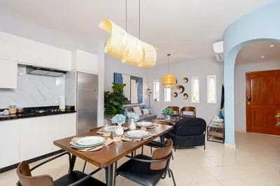 a kitchen and living room with a table and chairs at Charming 1 Bedroom in Tamarindo Dominicus With Pool in La Laguna