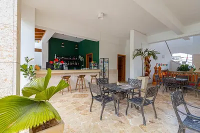 a restaurant with a table and chairs and a bar at Coastal Luxury 2-Bed w Pool Access in Paraiso Bayahibe in Bayahibe