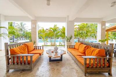 a living room with two couches and a table at Coastal Luxury 2-Bed w Pool Access in Paraiso Bayahibe in Bayahibe