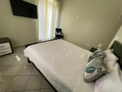 a bedroom with a bed and a television in it at Villa Michel in Laguna del Higüero