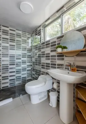 a bathroom with a toilet and a sink at Caribey 2, Las Terrenas in Las Terrenas