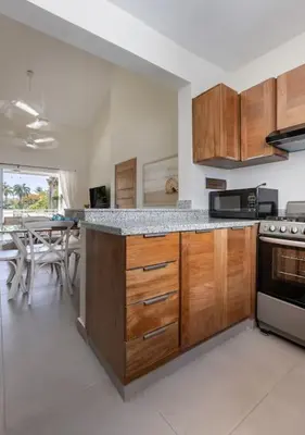 a kitchen with wooden cabinets and a counter top at Caribey 2, Las Terrenas in Las Terrenas