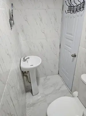 a white bathroom with a sink and a toilet at hermoso aparta estudio a 10 minutos del centro in San Felipe de Puerto Plata