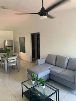 a living room with a couch and a table at Jungle Oasis by the Beach in San Felipe de Puerto Plata
