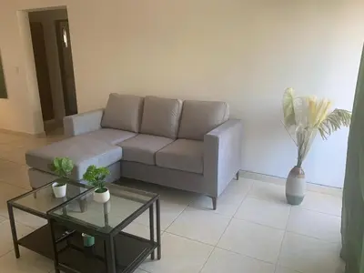 a living room with a couch and a table at Jungle Oasis by the Beach in San Felipe de Puerto Plata