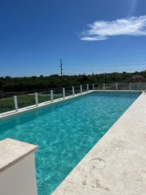 a swimming pool with blue water on a building at CGM BLUE 1hab in Bayahibe