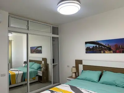 a bedroom with two beds and a mirror at CGM BLUE 1hab in Bayahibe
