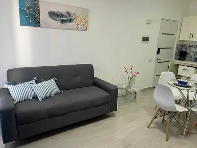 a living room with a couch and a table at CGM BLUE 1hab in Bayahibe