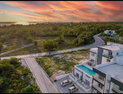 an aerial view of a building with a road and cars at CGM BLUE 1hab in Bayahibe