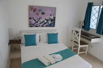 a bedroom with a bed with towels on it at Bayahibe Guest House Hotel in Bayahibe