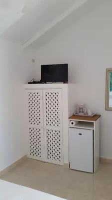 a kitchen with a white cabinet and a refrigerator at Bayahibe Guest House Hotel in Bayahibe
