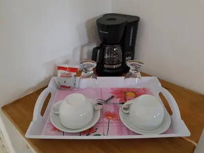 a tray with two dishes and a coffee maker on it at Bayahibe Guest House Hotel in Bayahibe