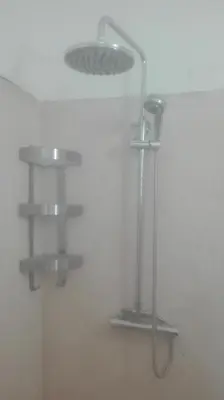 a shower in a bathroom with two shelves at Bayahibe Guest House Hotel in Bayahibe