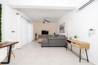 a living room with a couch and a table at Elegant 2 Bedroom Apartment with Pool in La Laguna