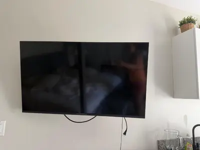 a flat screen tv hanging on a wall at Cadaques Caribe Palmera 101 in Bayahibe