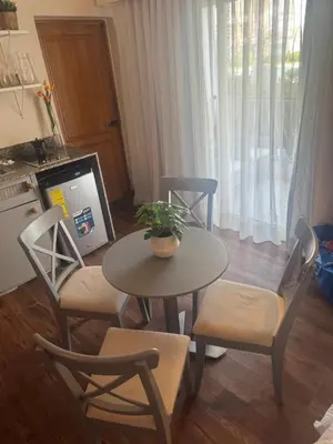 a kitchen with a table and chairs and a tv at Cadaques Caribe Palmera 101 in Bayahibe