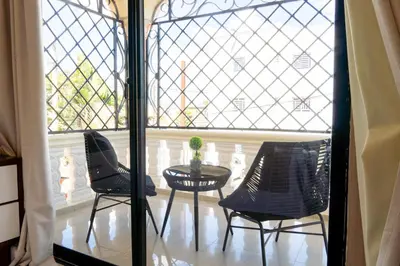 a room with two chairs and a table in front of a window at Casa familiar con piscina y cerca de la playa in La Belleza