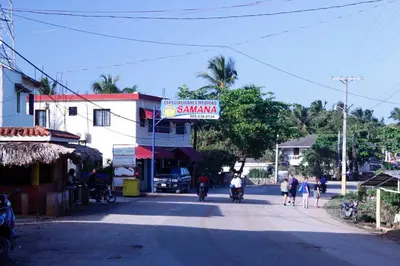 a group of people riding motorcycles down a street at Casa Por Que No in Las Galeras