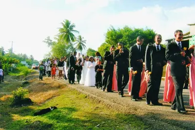 a wedding group of people walking down a road at Casa Por Que No in Las Galeras
