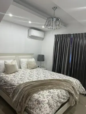 a bedroom with a bed and a chandelier at Con in Santo Domingo