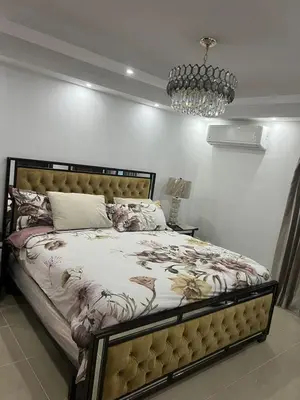 a bedroom with a large bed with a chandelier at Con in Santo Domingo