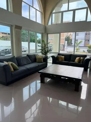 a living room with a couch and a coffee table at Hotel El Imperio Punta Cana in Punta Cana