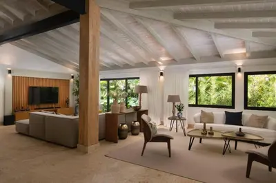 a living room with a couch and a table at Villa Laguna, Lush Oasis In Casa De Campo in La Romana