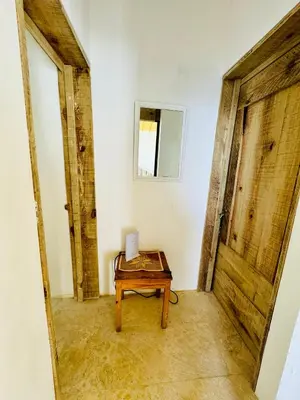 a room with a table and a door at Suami s room Casa Padura in Cabarete