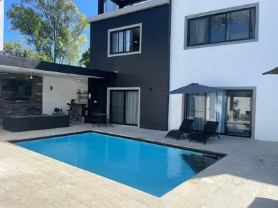 a swimming pool in the backyard of a house at Level suites #2 platinum in Sosúa