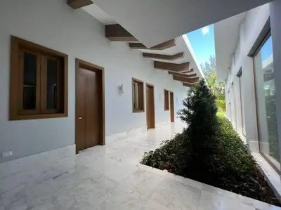 a hallway of a building with a plant at Villa Pradera, Upscale Comfort In Casa De Campo in La Romana