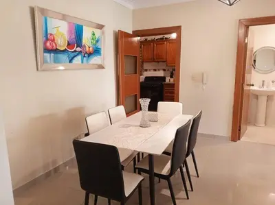 a dining room with a white table and chairs at Central Oasis Work or Explore the city in Santo Domingo