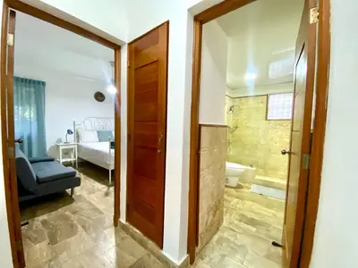 a bathroom with a door leading to a bedroom at The Best Place in los Corales RD Arenas De B in Punta Cana