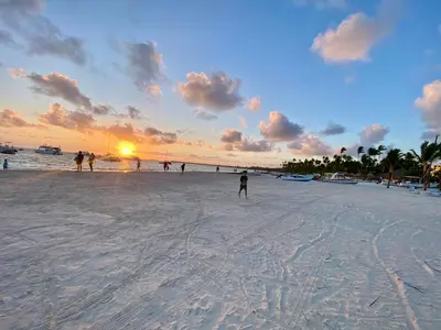 a group of people on a beach at sunset at The Best Place in los Corales RD Arenas De B in Punta Cana