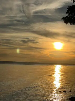 a sunset over a body of water with the sun at Ático riomar segundo piso in Santa Bárbara de Samaná