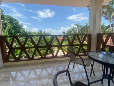 a balcony with a table and chairs and a view at Ático riomar segundo piso in Santa Bárbara de Samaná