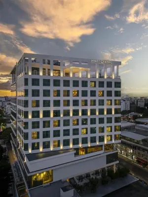 a large white building with lights on top of it at Hyatt Centric Santo Domingo in Santo Domingo