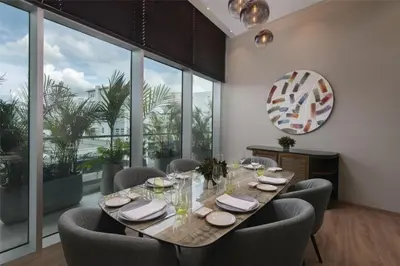a dining room with a table and chairs and windows at Hyatt Centric Santo Domingo in Santo Domingo
