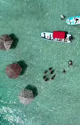 a group of people in the water with a surfboard at Mi Refugio in San Fernando de Monte Cristi