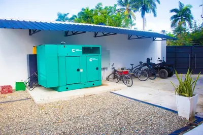 a green building with bikes parked next to a building at LEVEL suites #4 OMEGA in Sosúa