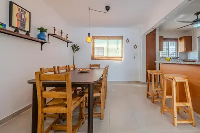 a kitchen and dining room with a table and chairs at la maguana - cozy and beautiful 3BR home with pool in Santiago de los Caballeros