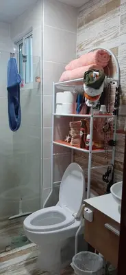 a bathroom with a toilet and a shower at La casa de Marcel et Nathalie in Baní