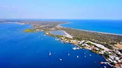 an island in the ocean with boats in the water at La casa de Marcel et Nathalie in Baní