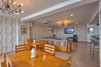 a dining room with wooden tables and chairs at Las Olas, Juan Dolio 2bed2bath Condo in Guayacanes