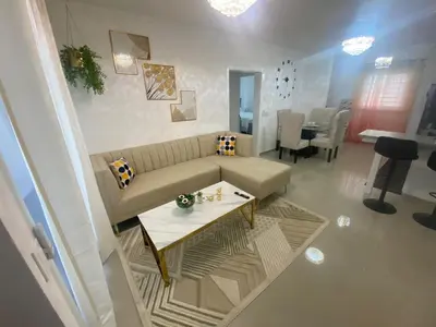 a living room with a couch and a table at Apartamento completo en Bayahibe in Bayahibe