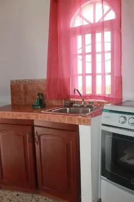 a kitchen with a sink and a window at Castillo Romano in Las Terrenas