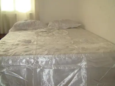 a bed covered in plastic in a bedroom at Castillo Romano in Las Terrenas