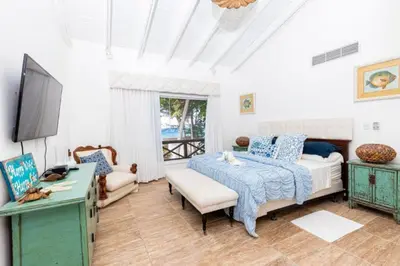 a bedroom with a bed and a tv in it at Penthouse frente al mar Playa Las Ballenas in Las Terrenas